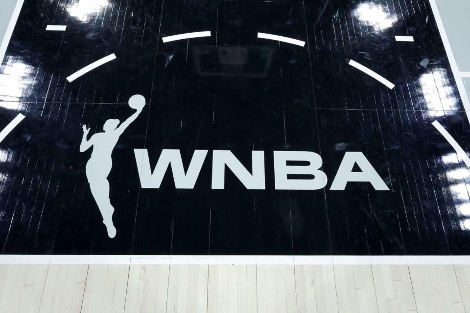 <p>Ethan Miller/Getty</p>  A WNBA logo is shown on a basketball court