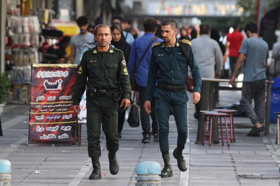 Members of Iran's police forces walk on a street during the revival of morality police in Tehran (via REUTERS)