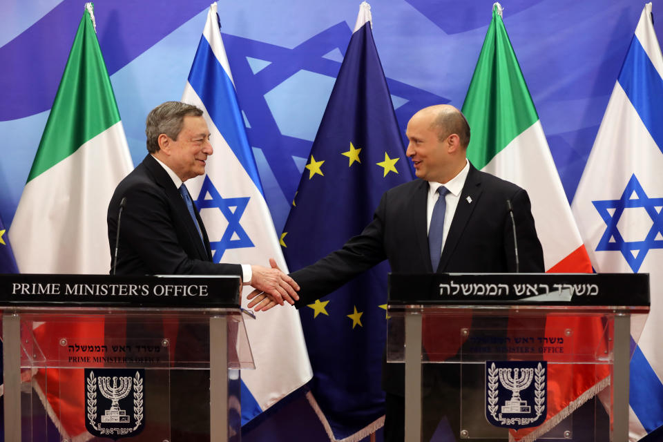 Italian Prime Minister Mario Draghi, left, shakes hands with Israeli Prime Minister Naftali Bennett during a press statement at the prime minster's office in Jerusalem, Israel, Tuesday, June 14, 2022. Draghi is on two-day official visit to Israel and the Palestinian authority. (Abir Sultan/Pool via AP)