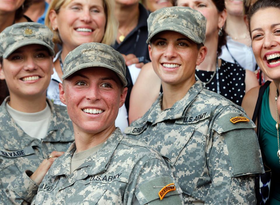 Army 1st Lt. Shaye Haver, center, and Capt. Kristen Griest, right, pose for photos on Aug. 21, 2015, at Fort Benning, Ga., after becoming the first female graduates at the Army's Ranger School.