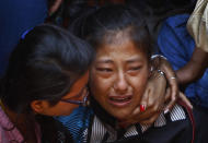 A relative of one of the Nepalese climbers killed in an avalanche on Mount Everest, cries during the funeral ceremony in Katmandu, Nepal, Monday, April 21, 2014. Buddhist monks cremated the remains of Sherpa guides who were buried in the deadliest avalanche ever recorded on Mount Everest, a disaster that has prompted calls for a climbing boycott by Nepal's ethnic Sherpa community. The avalanche killed at least 13 Sherpas. Three other Sherpas remain missing and are presumed dead. (AP Photo/Niranjan Shrestha)