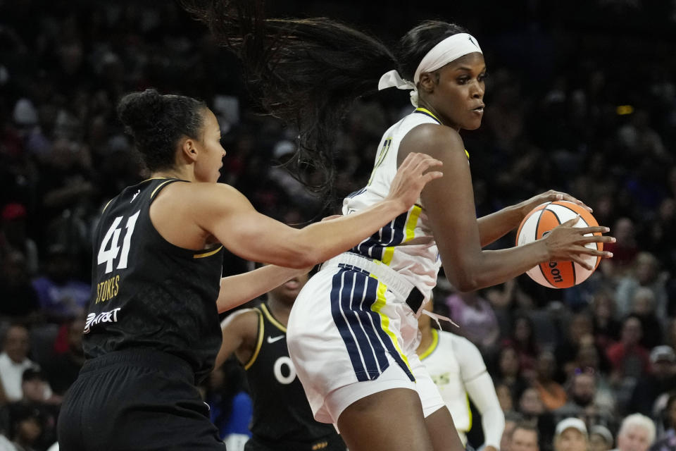 Dallas Wings center Kalani Brown, right, grabs a rebound around Las Vegas Aces center Kiah Stokes (41) during the second half in Game 2 of a WNBA basketball semifinal series Tuesday, Sept. 26, 2023, in Las Vegas. (AP Photo/John Locher)