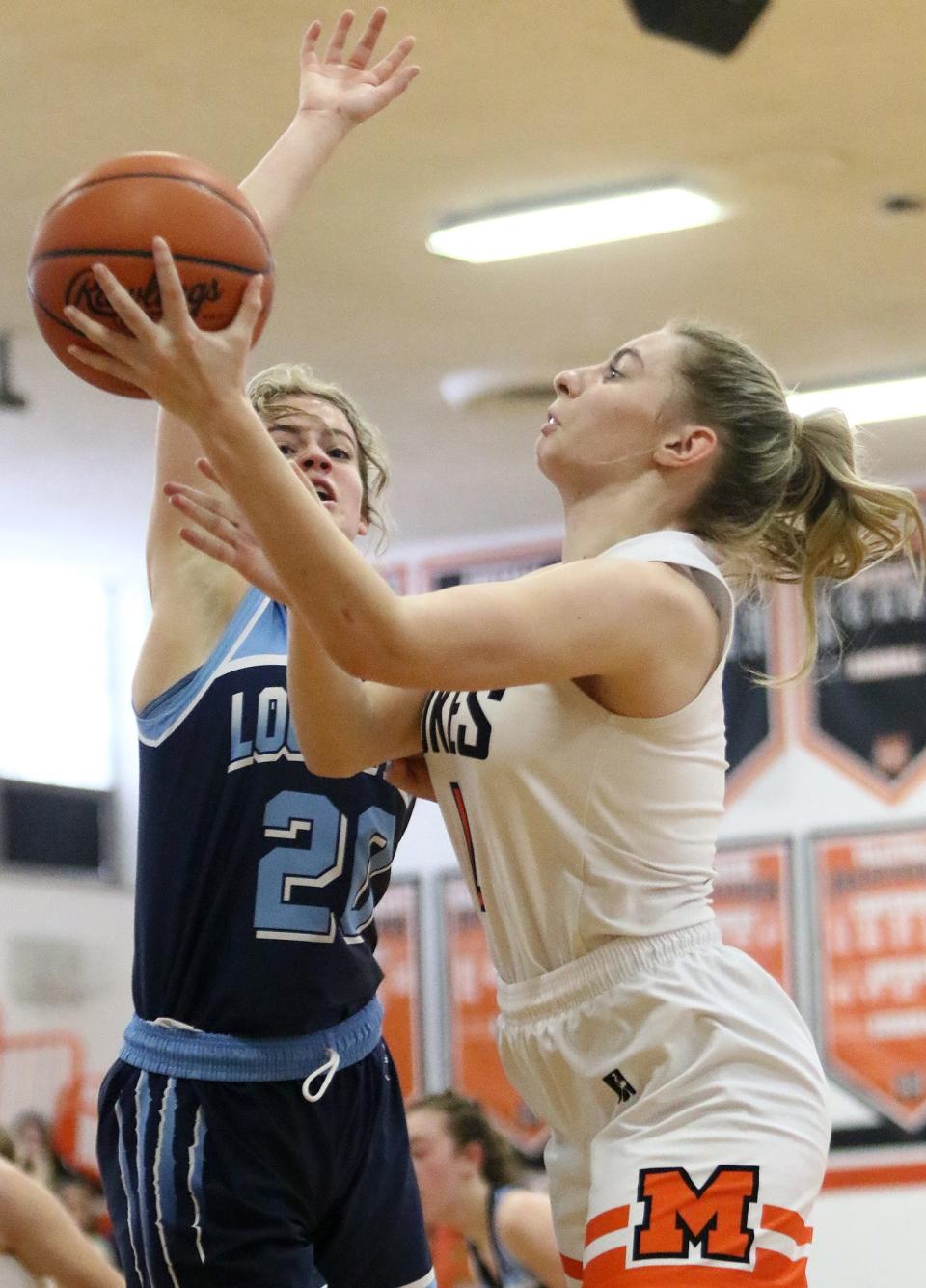 Marlington's Lexi Miller, right, is defended by Louisville's Delaney Orin during action Saturday afternoon at Marlington High School, January 28, 2023.