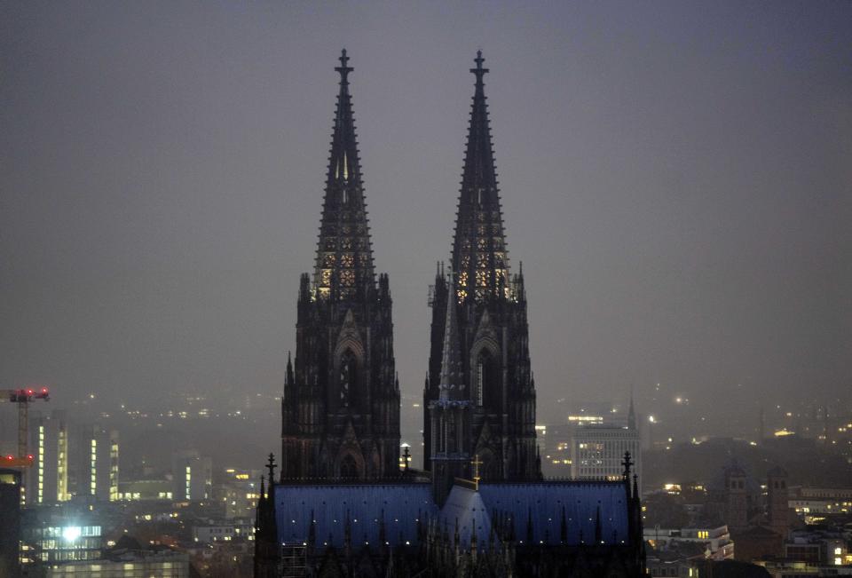 The illuminated city center with the Cathedral, in Cologne, Germany, Tuesday, Nov. 29, 2022. An unprecedented crisis of confidence is shaking the Archdiocese of Cologne. Catholic believers have protested their deeply divisive bishop and are leaving in droves over allegations that he may have covered up clergy sexual abuse reports. (AP Photo/Michael Probst)