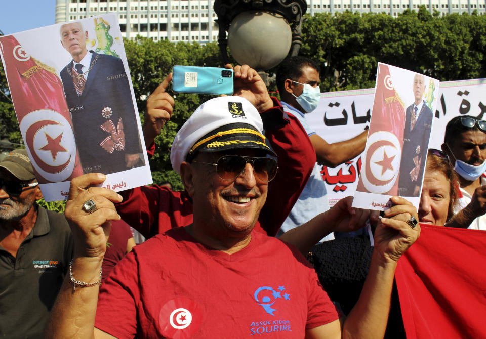 Tunisians demonstrate in support of Tunisian President Kais Saied in Tunis, Tunisia, Sunday, Oct. 3, 2021. President Saied froze the country's parliament and sacked the prime minister on July 25, 2021. (AP Photo/Hassene Dridi)