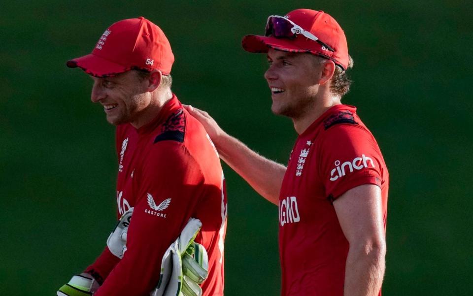 England's captain Jos Buttler, left, and Sam Curran celebrate winning against Namibia