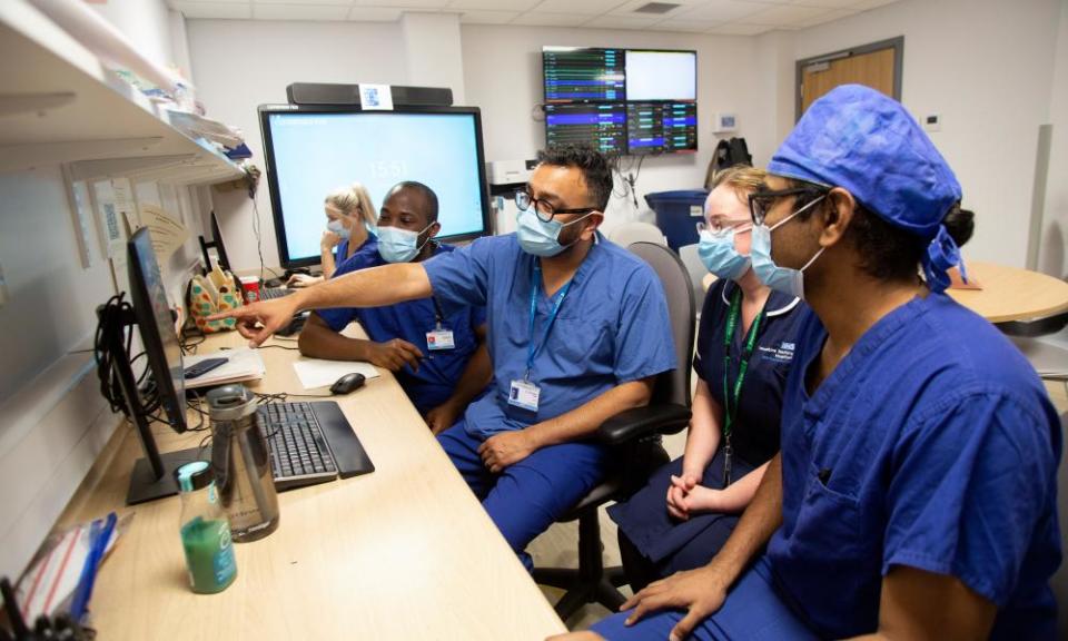 Dr Shondipon Laha, a critical care consultant, inspecting patients’ x-rays with colleagues at the Royal Preston hospital