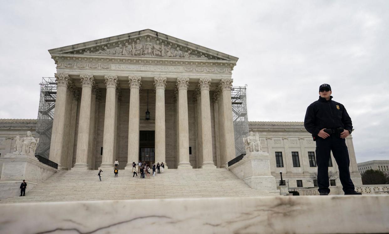 <span>A supreme court police officer stands outside the court building on 4 March 2024. </span><span>Photograph: Kevin Lamarque/Reuters</span>