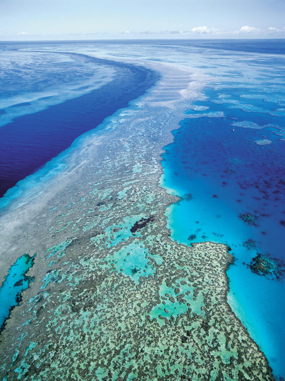 FILE - In this Sept. 2001 file photo provided by provided by Queensland Tourism, an aerial view shows the Great Barrier Reef off Australia's Queensland state. Ocean acidification has emerged as one of the biggest threats to coral reefs across the world, acting as the "osteoporosis of the sea" and threatening everything from food security to tourism to livelihoods, the head of a U.S. scientific agency said Monday, July 9, 2012. (AP Photo/Queensland Tourism, File) EDITORIAL USE ONLY