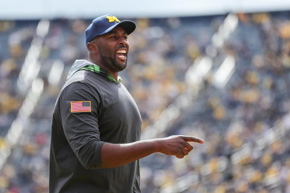 Michigan offensive coordinator Sherrone Moore talks to players during warm up ahead of the UNLV game at Michigan Stadium in Ann Arbor on Saturday, Sept. 9, 2023.