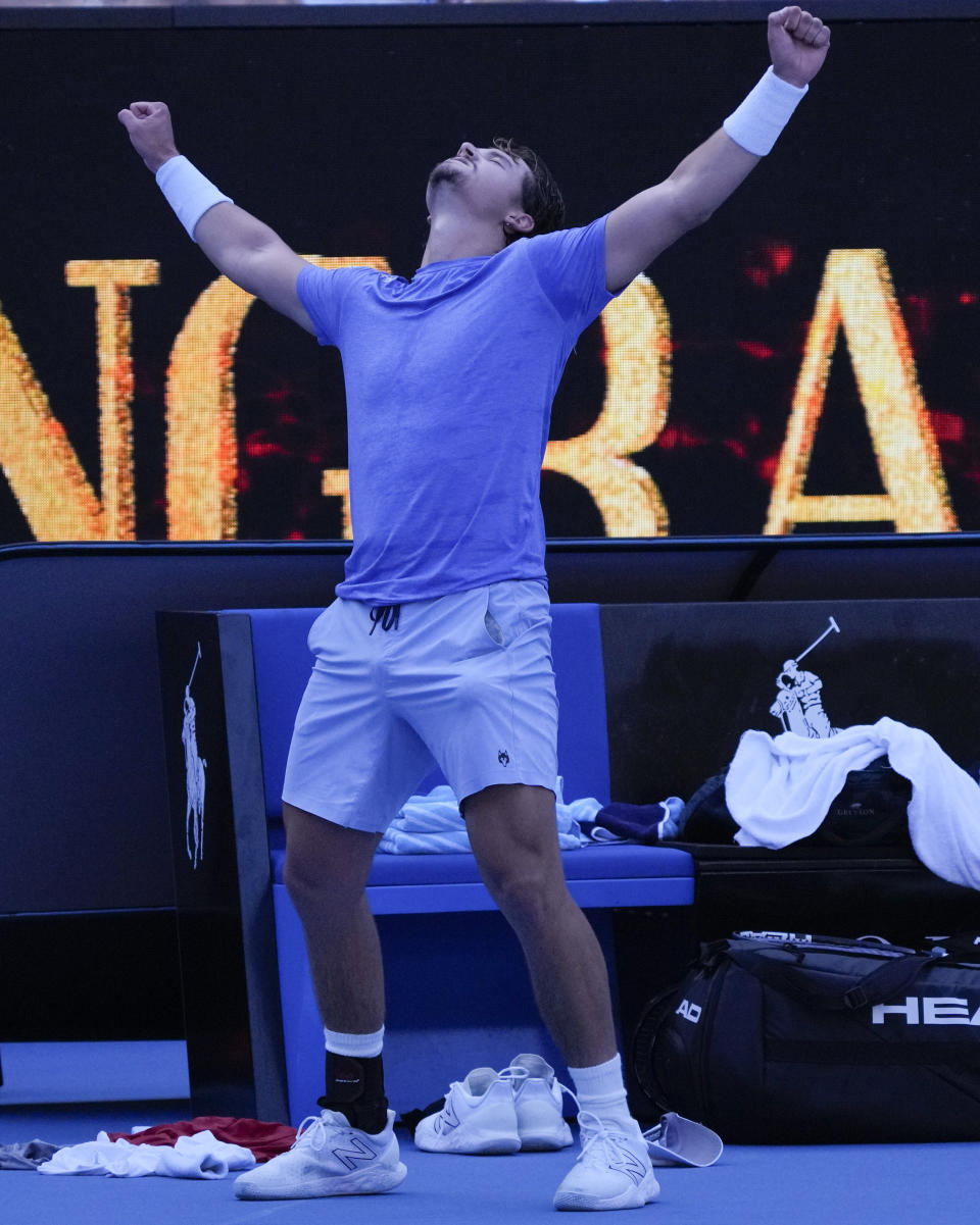 J.J. Wolf of the U.S. celebrates after defeating compatriot Michael Mmoh in their third round match at the Australian Open tennis championship in Melbourne, Australia, Saturday, Jan. 21, 2023. (AP Photo/Dita Alangkara)