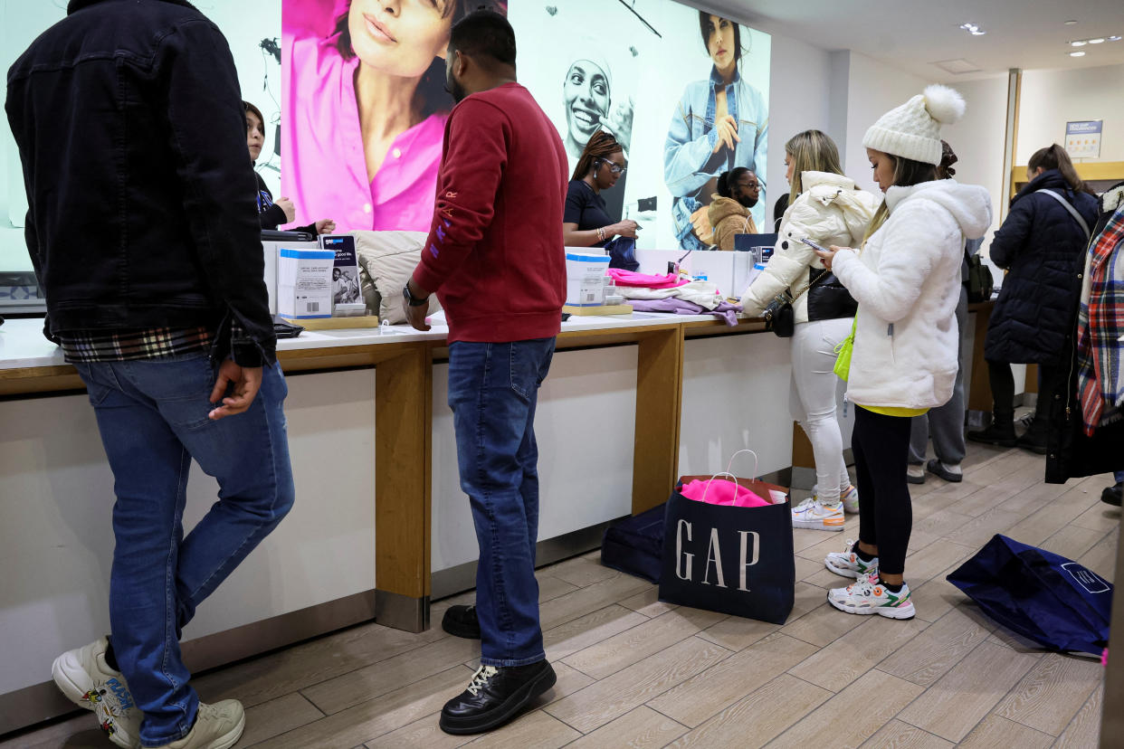 Shoppers looking for early Black Friday sales checkout at a Gap Store in Times Square on the Thanksgiving holiday in New York City, U.S., November 24, 2022. REUTERS/Brendan McDermid