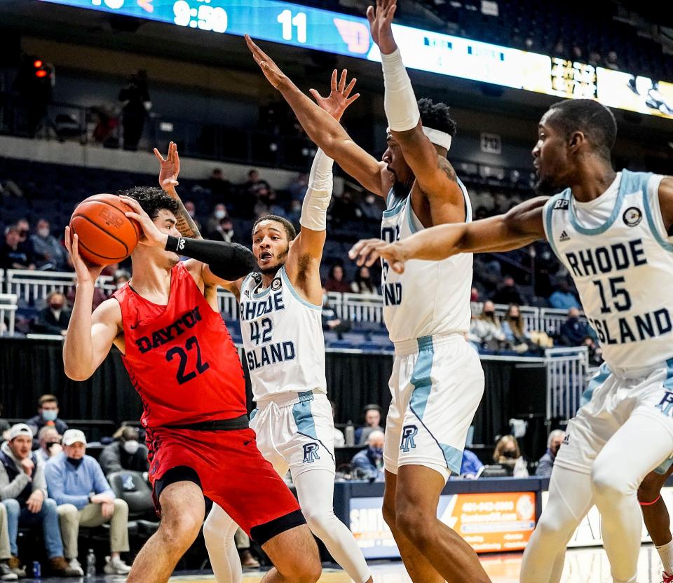 The URI defense closes in on Dayton's Mustapha Amzil in the first half of a February game last season. The Rams will host the Flyers — who were once coached by now-Rams head coach Archie Miller — during their 18-game conference schedule this season.