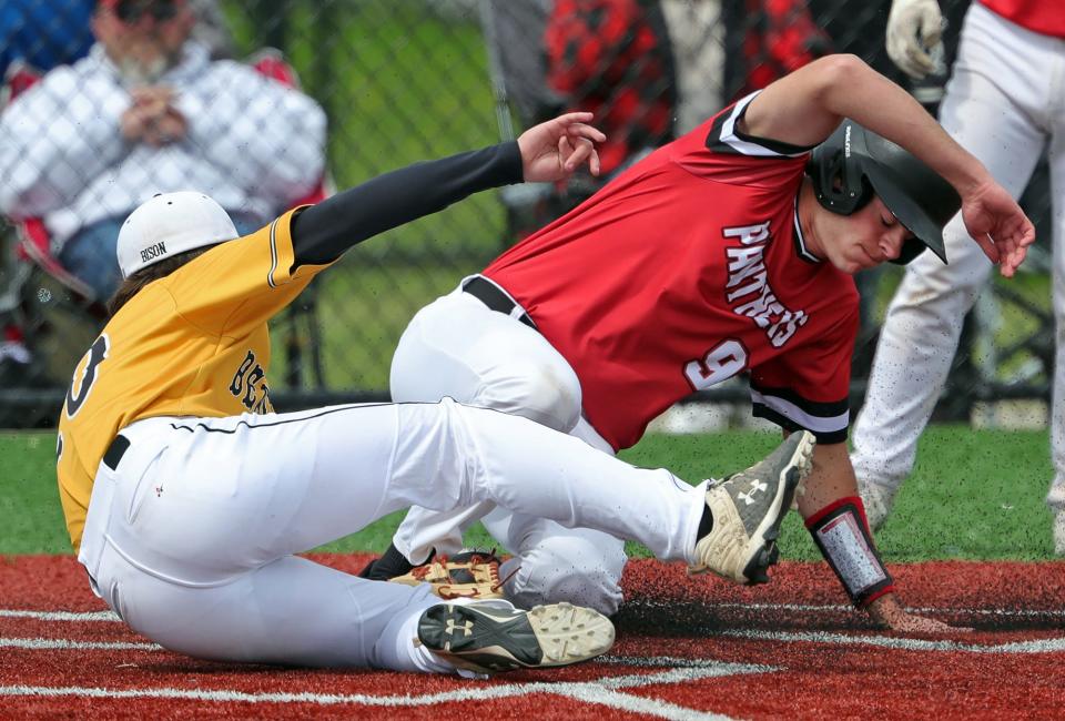 Norton base-runner Cooper Nipuelio, right, scores on a wild pitch by Beachwood pitcher Josh Rosenblitt during the fifth inning of a Division II district semifinal at North Ridgeville on Monday. Norton won 5-2.