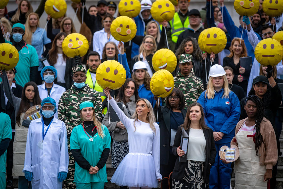 A crowd of almost 100 workers comprising 11 different sectors hold emoji-shaped balloons to  illustrate new insights from Indeedâ€™s â€˜Work Happiness Scoreâ€™, the worldâ€™s largest study of work happiness. The event acts as a stark warning to employees and employers of the scale of unhappiness across the nation, as the data shows that over a third of the UKâ€™s workforce is unhappy in their job. The study, which has been developed with guidance from the Wellbeing Research Centre at Oxford University, found that real estate, management and consulting and the automotive industries are the unhappiest, while education, aerospace and defence and the media are the countryies happiest (SWNS)