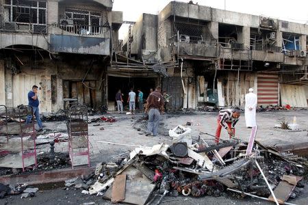 People gather at the site of car bomb in New Baghdad, July 22, 2015. REUTERS/Khalid al-Mousily