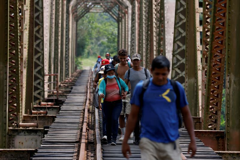 FILE PHOTO: A group of migrants from Honduras walk along the railway track on their way to the United States in Huimanguillo