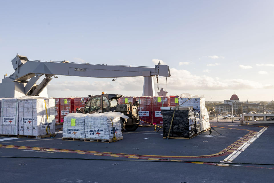 FILE - In this photo provided by the Australian Defence Force, aid supplies are stacked on board HMAS Adelaide as the ship arrives in Nuku'alofa, Tonga, Wednesday, Jan. 26, 2022, carrying disaster relief and humanitarian aid supplies. The Pacific archipelago nation of Tonga is in lockdown after detecting its first community transmission of COVID-19, which appears to have been brought in by aid workers delivering supplies of fresh water and medicine after last month's volcanic eruption and tsunami. (CPL Robert Whitmore/Australian Defence Force via AP)