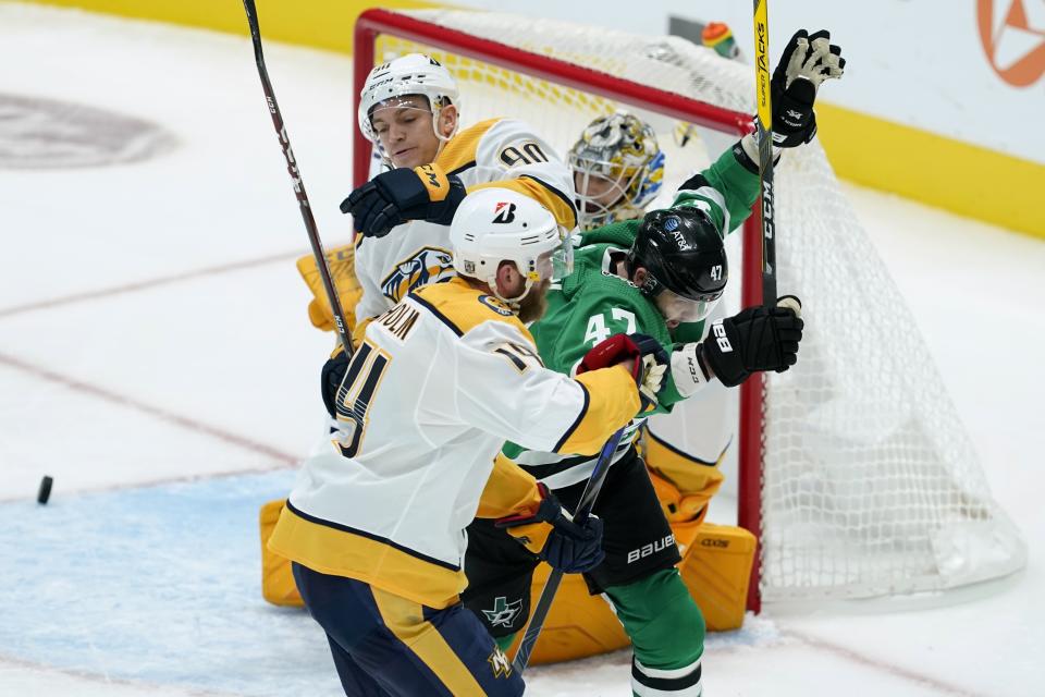 Dallas Stars right wing Alexander Radulov (47) celebrates his goal, between between Nashville Predators defensemen Mattias Ekholm (14) and Mark Borowiecki (90) during the second period of an NHL hockey game in Dallas, Friday, Jan. 22, 2021. (AP Photo/Tony Gutierrez)