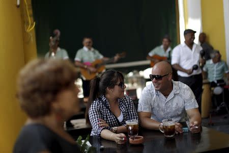 People enjoy drinks at a brewery in Havana March 16, 2016. REUTERS/Ueslei Marcelino