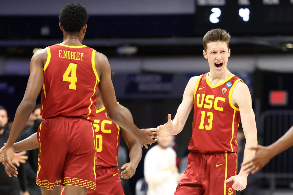 INDIANAPOLIS, INDIANA - MARCH 22: Drew Peterson #13 and Evan Mobley #4 of the USC Trojans react in the first half of their second round game against the Kansas Jayhawks in the 2021 NCAA Men's Basketball Tournament at Hinkle Fieldhouse on March 22, 2021 in Indianapolis, Indiana. (Photo by Andy Lyons/Getty Images)