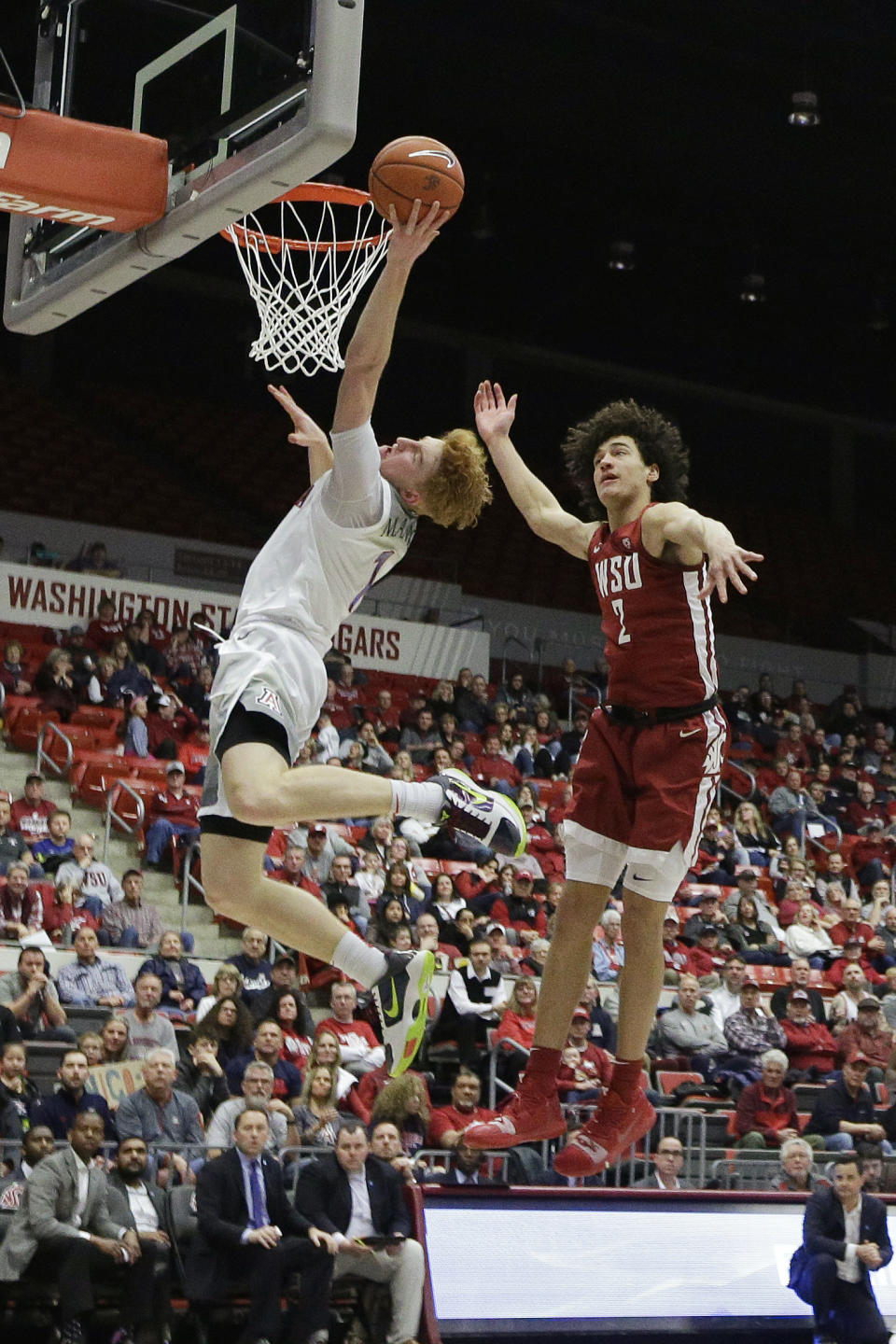 Arizona guard Nico Mannion, left, shoots in front of Washington State forward CJ Elleby during the second half of an NCAA college basketball game in Pullman, Wash., Saturday, Feb. 1, 2020. Arizona won 66-49. (AP Photo/Young Kwak)