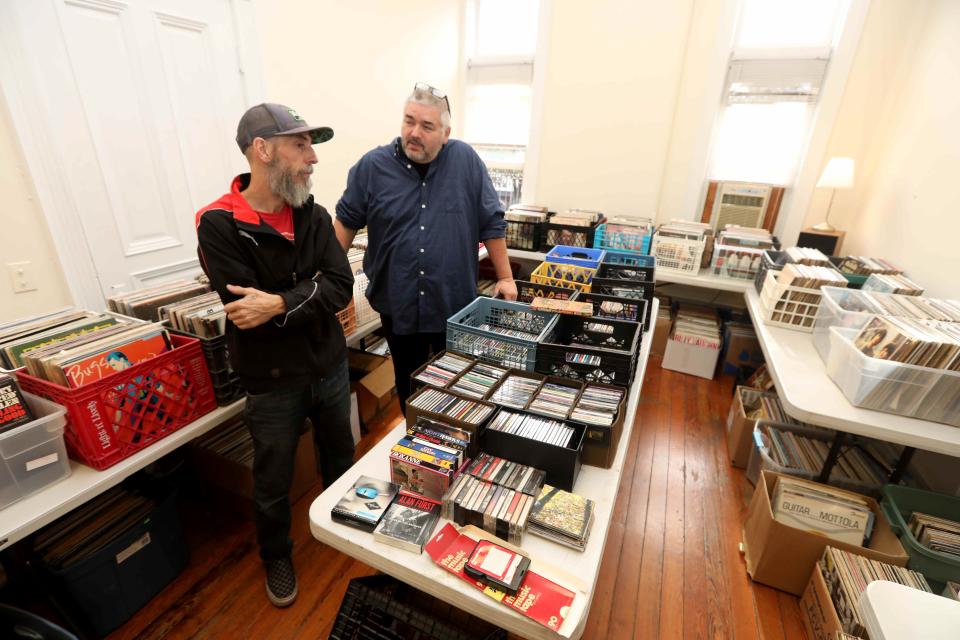Greg Jacquin, who runs, Marquee Records, a used record shop located above the Tarrytown Music Hall, and Bjorn Olsson, Executive Director of the music Hall, stand amidst the hundreds of used records, CD's, and cassette tapes on sale at the shop Nov. 17, 2021. Jacquin, who has volunteered at the music hall for years, started the record shop earlier this year as a way to raise money to support the concert venue. Most records are sold for $2 each. Since opening in April of this year, the record shop has made over $8,000.