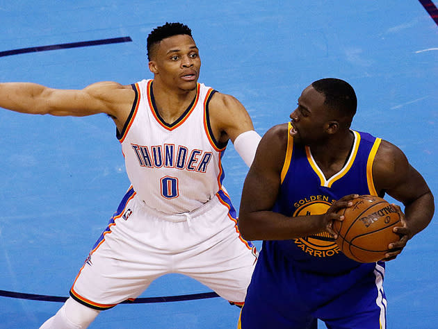 Russell Westbrook envelops Draymond Green. (Getty Images)