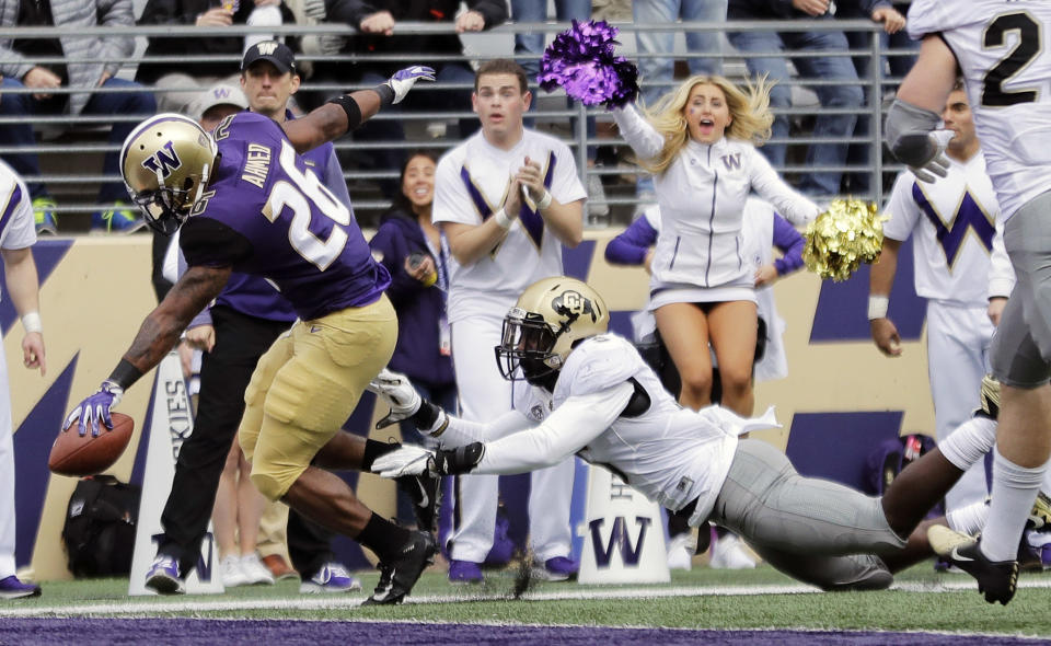 Washington running back Salvon Ahmed, left, scores a touchdown ahead of Colorado linebacker Davion Taylor during the first half of an NCAA college football game, Saturday, Oct. 20, 2018, in Seattle. (AP Photo/Ted S. Warren)