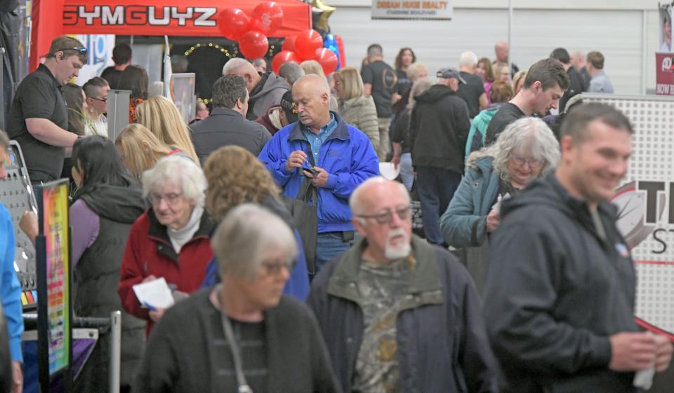 Visitors walk the aisles of the 17th annual Richland Area Chamber & Economic Development Expo at the Richland County Fairgrounds.