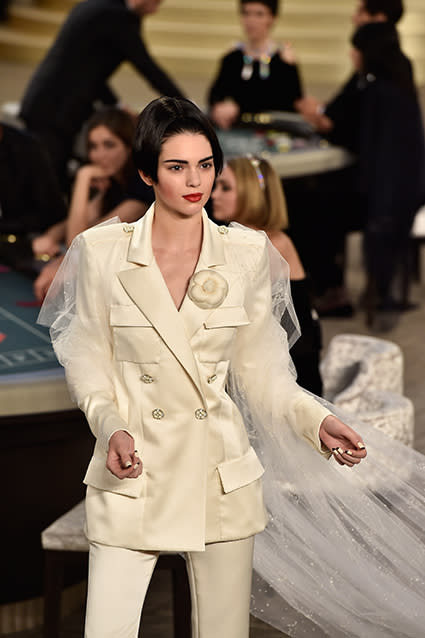 Well this is certainly a new look for Kendall Jenner! The 19-year-old supermodel walked the Chanel runway on Tuesday, trading in her long dark locks for a severe, stick-straight bob. Proving she can pull off just about any look, Kendall was a standout in an edgy off-white pantsuit complete with a long train. <strong>WATCH: Kendall Jenner Flashes Her Butt Cheeks In Shortest Shorts Imagineable</strong> Getty Images Getty Images Getty Images Cementing her status in the high-fashion world, Kendall was the chosen model to strike a pose with legendary Chanel designer Karl Lagerfeld at the end of the show, which she of course happily Instagrammed about. "Of course I said yes. #Chanel #HauteCouture," she wrote. Check out Kendall and Karl looking like a bride and groom. The reality star's already made an impressive mark on Paris Fashion Week, walking the Versace runway on Sunday. Getty Images <strong>WATCH: Kendall Jenner and a Shirtless Justin Bieber Star in Sexy 'Vogue' Shoot</strong> In March, Kendall memorably graced the Chanel runway, but with her bestie, supermodel Cara Delevingne. Watch below: