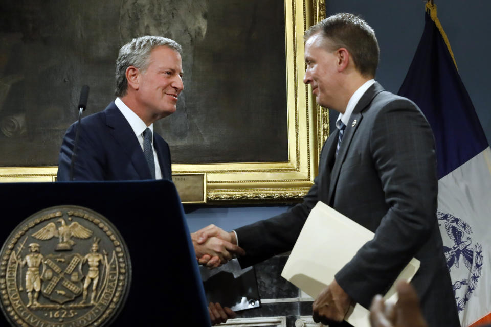 New York Mayor Bill de Blasio, left, shakes hands with incoming New York City Police Commissioner, current Chief of Detectives Dermot Shea, as he introduces Shea at New York's City Hall, Monday, Nov. 4, 2019. New York City's police commissioner is retiring after three years in charge of the nation's largest police department, Mayor Bill de Blasio said Monday. (AP Photo/Richard Drew)