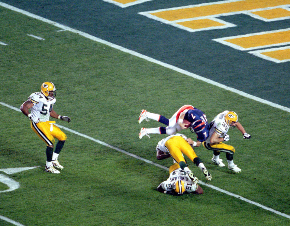 Denver quarterback John Elway goes airborne to pick up a first down in Super Bowl XXXII at Qualcomm Stadium in San Diego, CA. The Broncos defeated the Green Bay Packers 31-24 on 1/25/1998. (Photo by Kevin Reece/Getty Images)