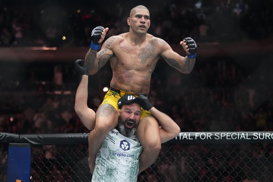 Brazil's Alex Pereira celebrates after a light heavyweight title bout against Czech Republic's Jirí Procházka at the UFC 295 mixed martial arts event, early Sunday, Nov. 12, 2023, in New York. (AP Photo/Frank Franklin II)