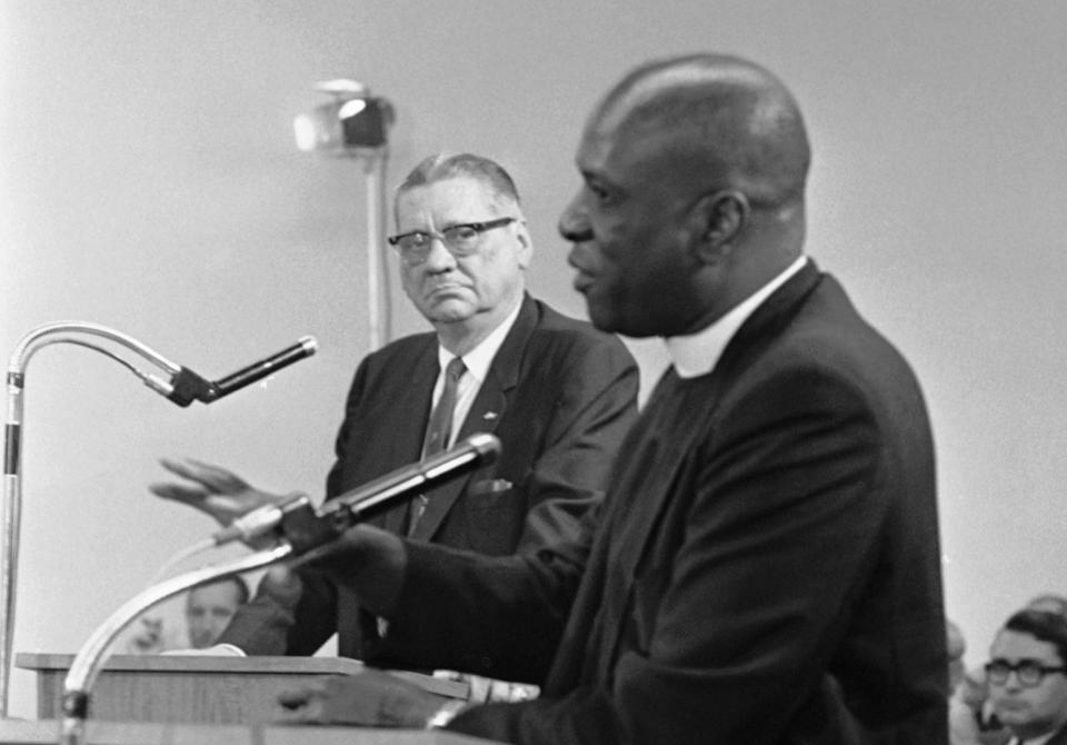 Image: Rev. Theodore Gibson, right, active in fostering smooth interracial relations in Miami, Fla., tells the Miami City Commission he favors strong action against crime, Dec. 30, 1967. He added he believed Miami Police Chief Walter Headley, left, (Jim Bourdier / AP file)