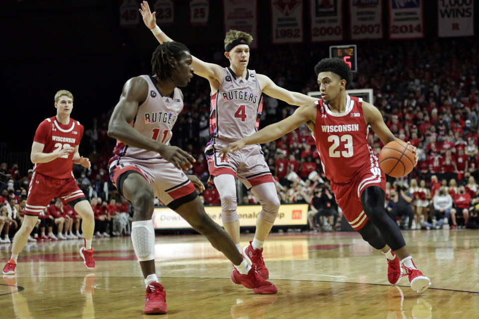 Wisconsin guard Chucky Hepburn (23) drives to the basket past Rutgers guard Paul Mulcahy (4) and center Clifford Omoruyi (11) during the first half of an NCAA college basketball game Saturday, Feb. 26, 2022, in Piscataway, N.J. (AP Photo/Adam Hunger)