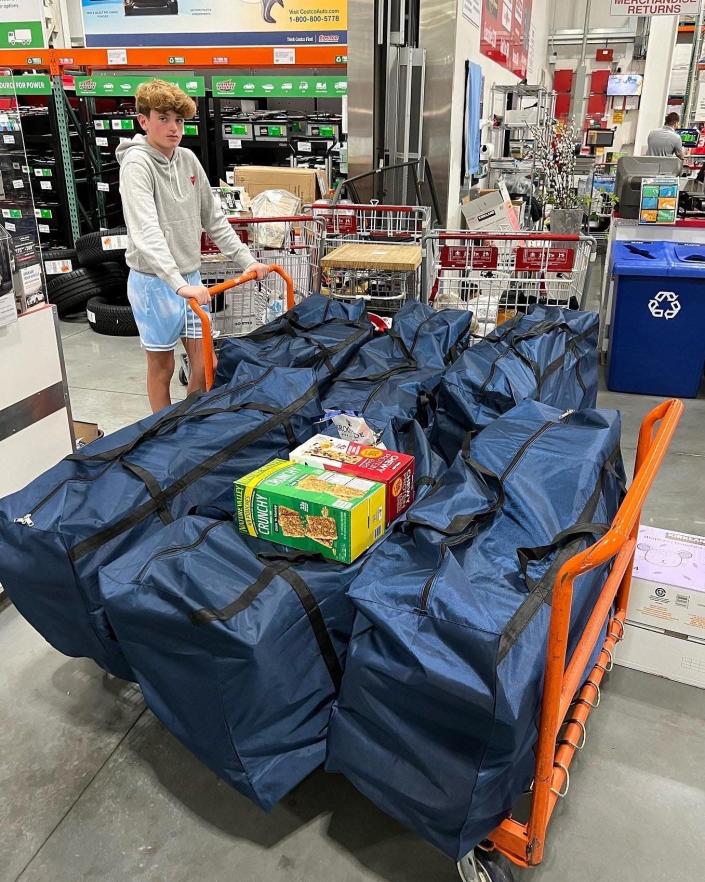 Trevor&#xa0;Ostfeld, 15, shops at Costco with some of the large duffel bags he helped transport to Poland and Ukraine with supplies for people fleeing the Russian invasion.