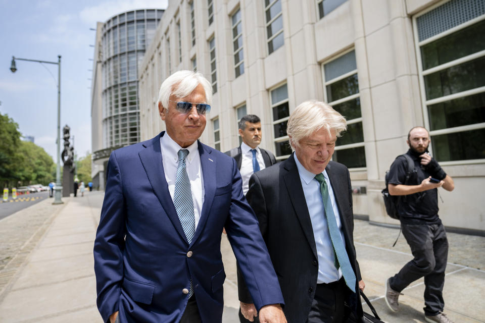 FILE - Horse trainer Bob Baffert, left, leaves federal court in the Brooklyn borough of New York, Monday, July 12, 2021. The Breeders' Cup is allowing Baffert, currently embroiled in legal fights in New York and Kentucky for multiple positive drug tests involving some of his horses, to enter horses (he has eight total), but he has to meet certain conditions, including stricter out-of-competition testing of his horses and greater security at his barn .(AP Photo/John Minchillo, File)