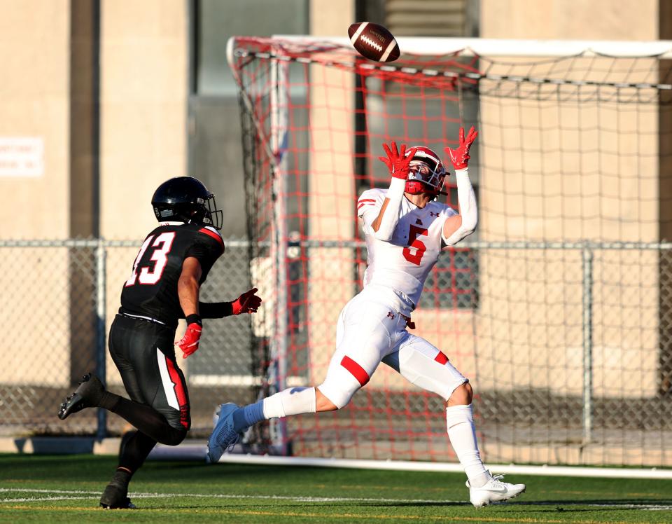 American Fork’s Davis Andrews reaches up for a long pass and touchdown ahead of West’s Lava Vailahi as the two teams play in Salt Lake City on Friday, Aug. 25, 2023. AF won 45-21.