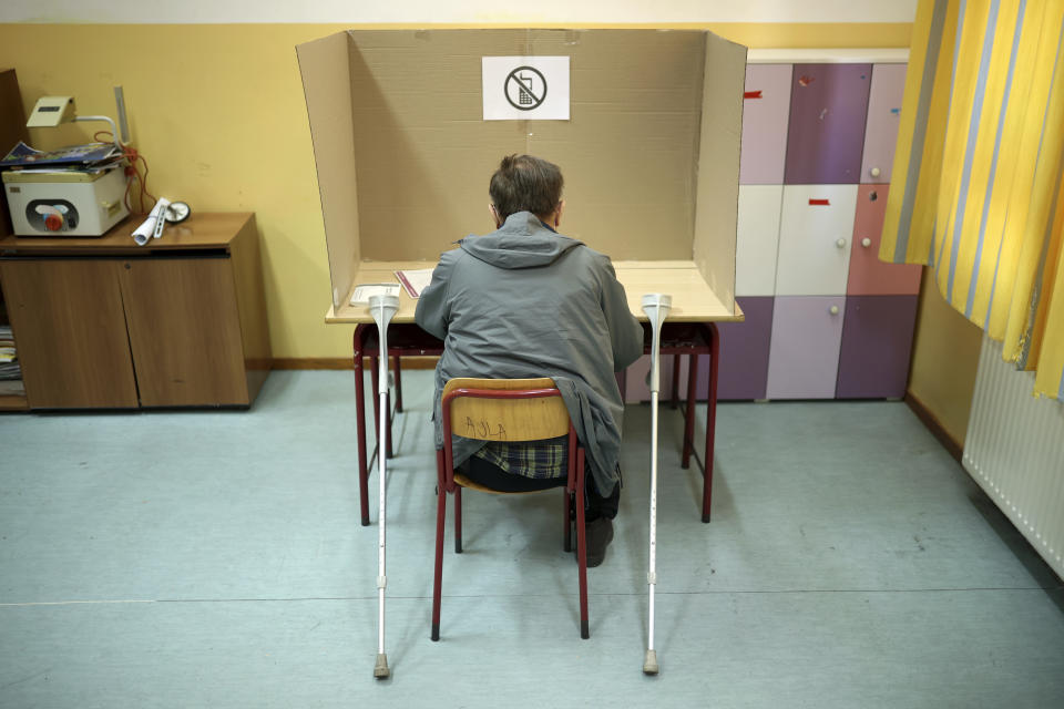 Man votes at a poling station in Sarajevo, Bosnia, Sunday, Oct. 2, 2022. Polls opened Sunday in Bosnia for a general election that is unlikely to bring any structural change despite palpable disappointment in the small, ethnically divided Balkan country with the long-established cast of sectarian political leaders. (AP Photo/Armin Durgut)