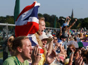 Fans celebrate match point as they watch the men's final on the tv screen on court three as Great Britain's Andy Murray wins during day thirteen of the Wimbledon Championships at The All England Lawn Tennis and Croquet Club, Wimbledon.