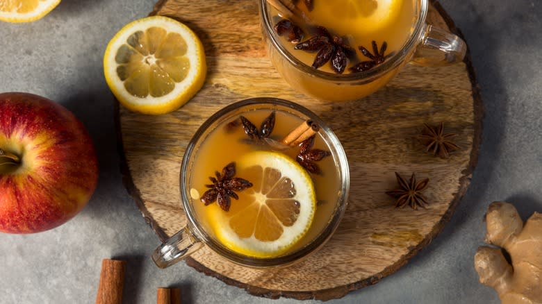 cups of wassail on wood