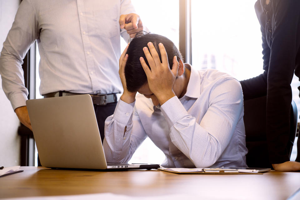 Business people blaming frustrated male colleague in Office. Negative human emotions concept