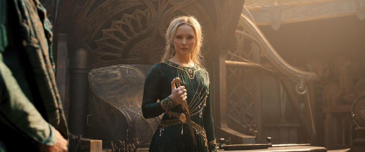 morfydd clark as galadriel in a green dress holding a dagger, lord of the rings the rings of power