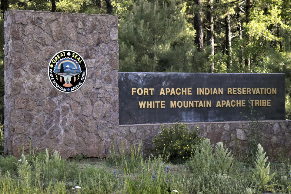 This Thursday, June 25, 2020 photo provided by C.M. Clay, shows the entrance to Fort Apache Indian Reservation in eastern Arizona. The reservation, home to the White Mountain Apache Tribe, will be under lockdown this weekend to help slow the spread of the coronavirus. (C.M. Clay/White Mountain Apache Tribe via AP)
