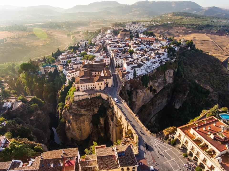 A still photo of the cliffside city of Ronda from above.