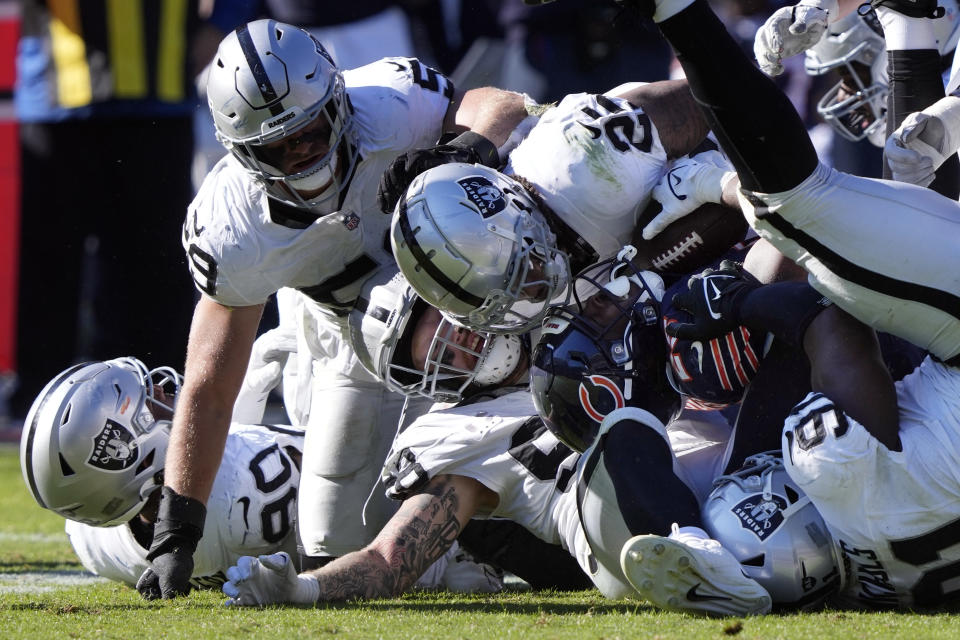 Las Vegas Raiders defenders cover Chicago Bears running back Darrynton Evans (25) in the second half of an NFL football game Sunday, Oct. 22, 2023, in Chicago. (AP Photo/Charles Rex Arbogast)