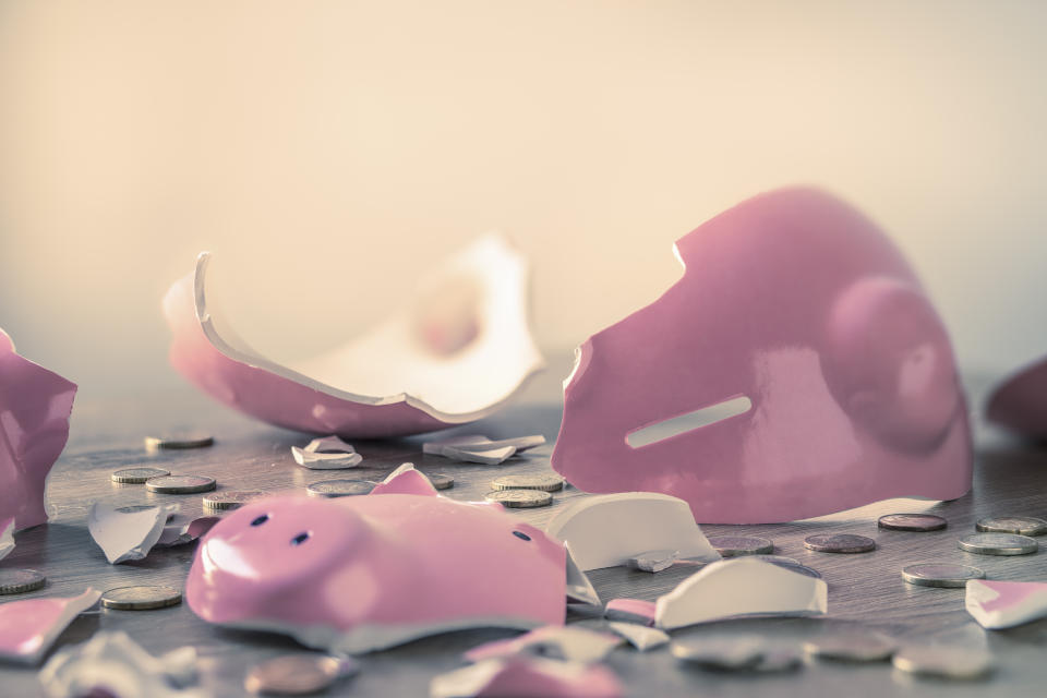 Broken piggy bank and coins