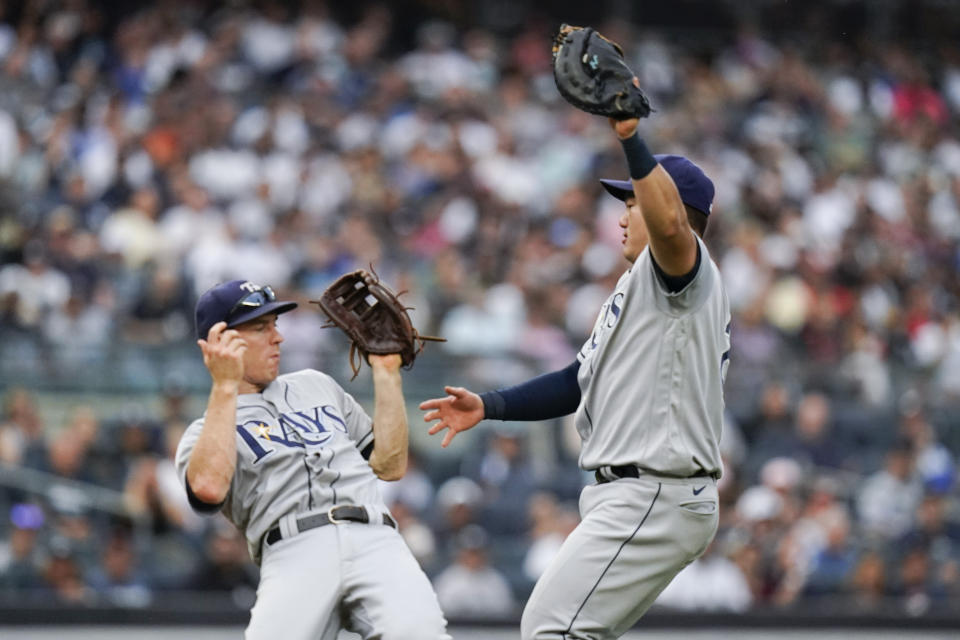 Tampa Bay Rays first baseman Ji-Man Choi, of Korea, right, and third baseman Joey Wendle collide as Choi caught a pop fly by New York Yankees' Giancarlo Stanton for an out during the seventh inning of a baseball game Sunday, Oct. 3, 2021, in New York. (AP Photo/Frank Franklin II)
