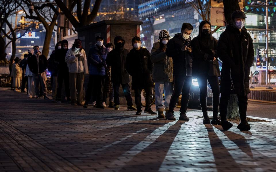 People line up for testing in Beijing. A downgrade could see an end to compulsory testing - Kevin Frayer/Getty Images